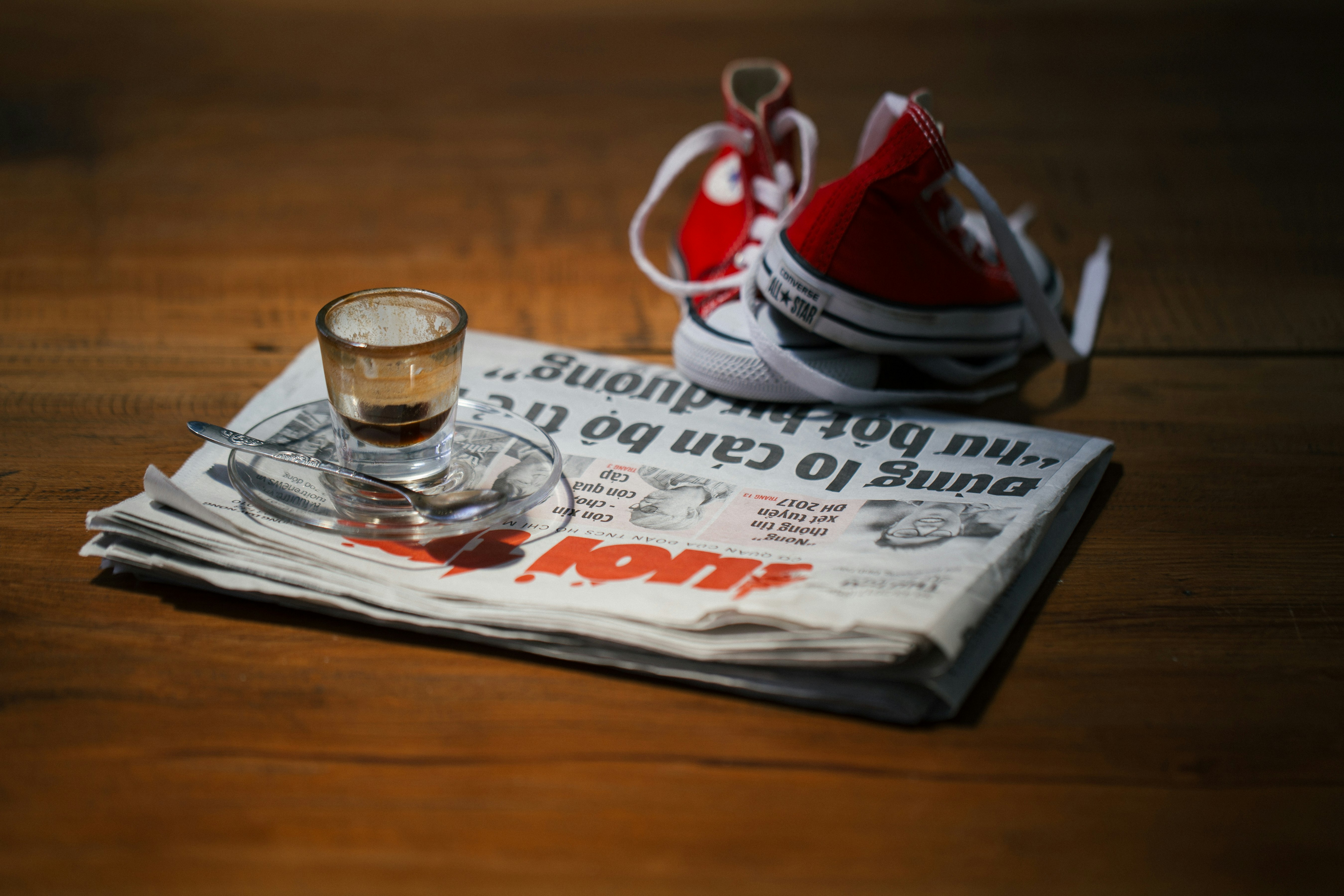 teacup on saucer on top of newspaper